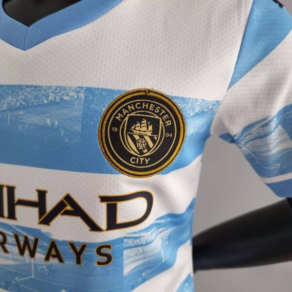 Manchester City 2022/23 Anniversary Kids Jersey And Shorts Kit - Image 5